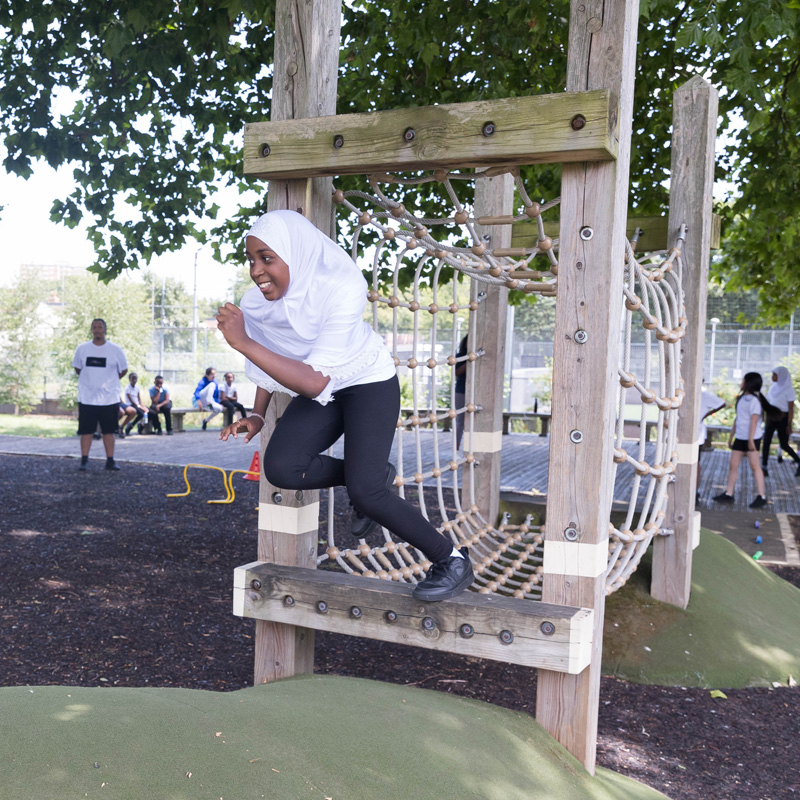 child jumping of climbing frame